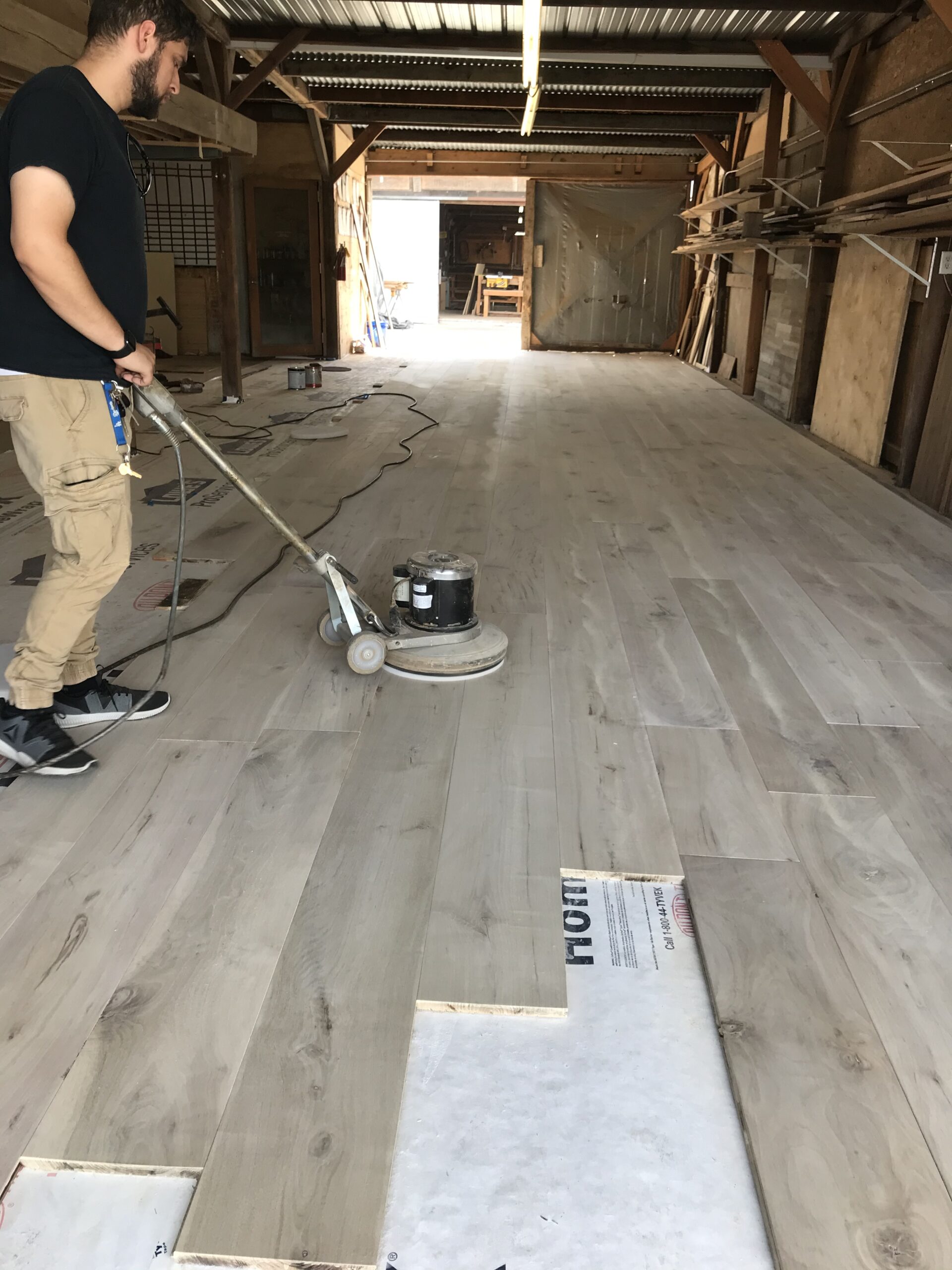 Close-up of walnut flooring with a rich bean stain finish, showcasing dark luxurious hues, intricate grain patterns, and a warm, glossy surface.